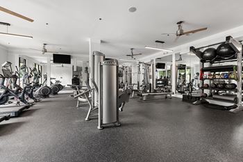 A spacious gym with a variety of equipment including treadmills, weights, and exercise machines.